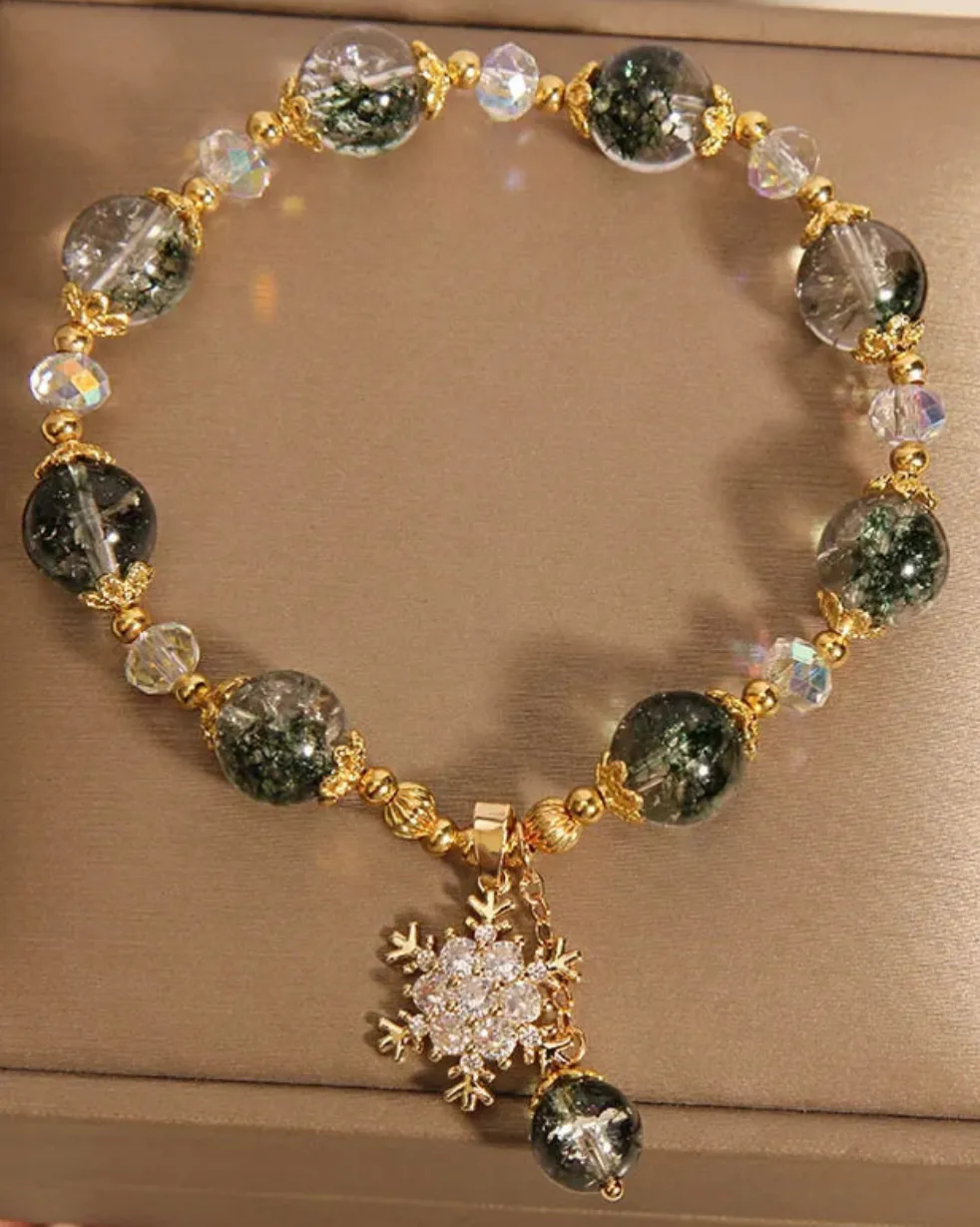 Bracelet de perles vertes & transparentes avec pendentif flocon orné de strass blanc & cuivré (1 coloris)