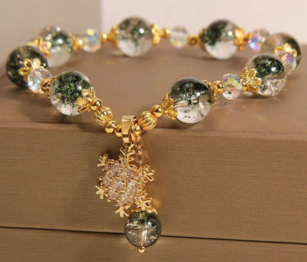 Bracelet de perles vertes & transparentes avec pendentif flocon orné de strass blanc & cuivré (1 coloris)