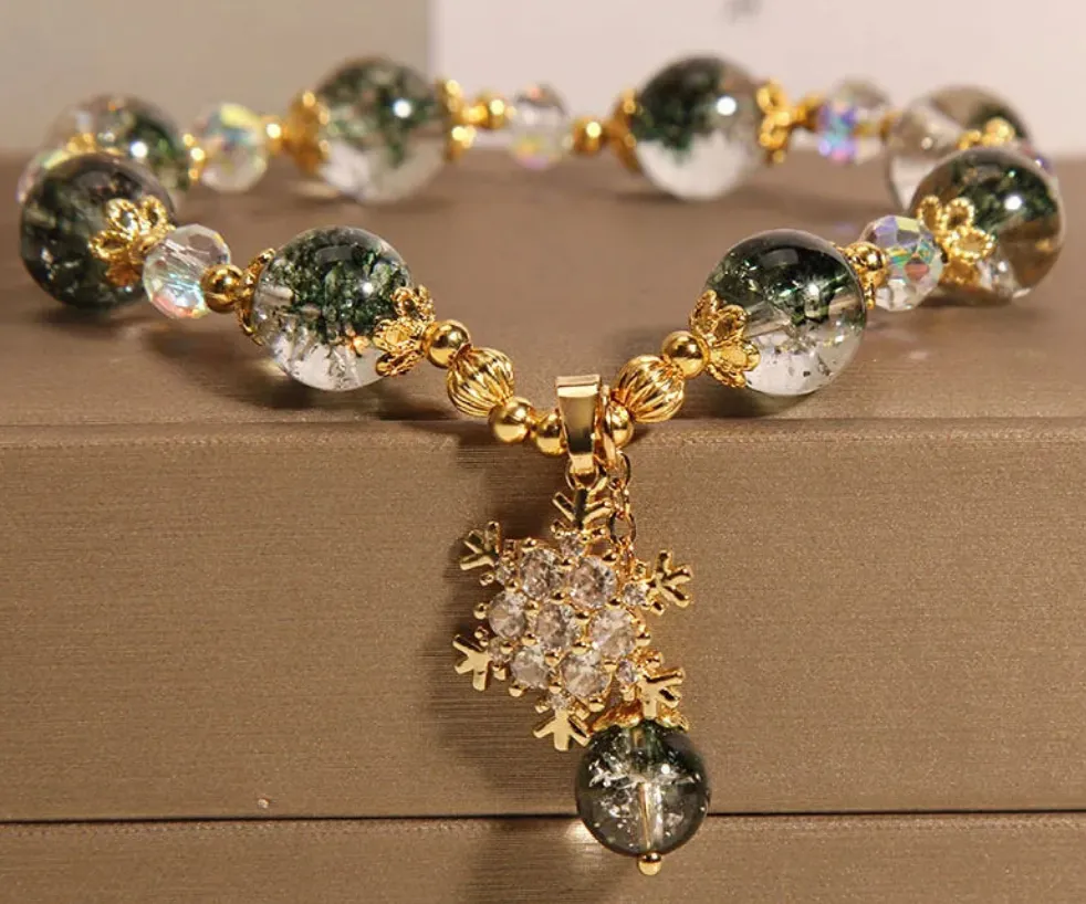 Bracelet de perles vertes & transparentes avec pendentif flocon orné de strass blanc & cuivré (1 coloris)