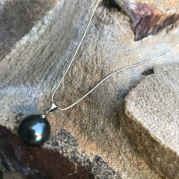 Large black mother of single pearl on silver chain