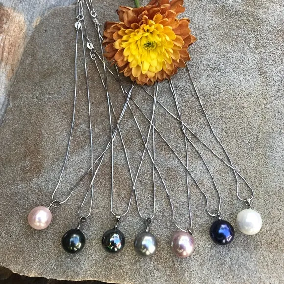 Large black mother of single pearl on silver chain