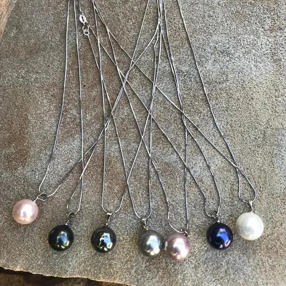 Large black mother of single pearl on silver chain