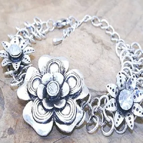Metal flower bracelet with CZ's. 18cm long   7cm extension chain.