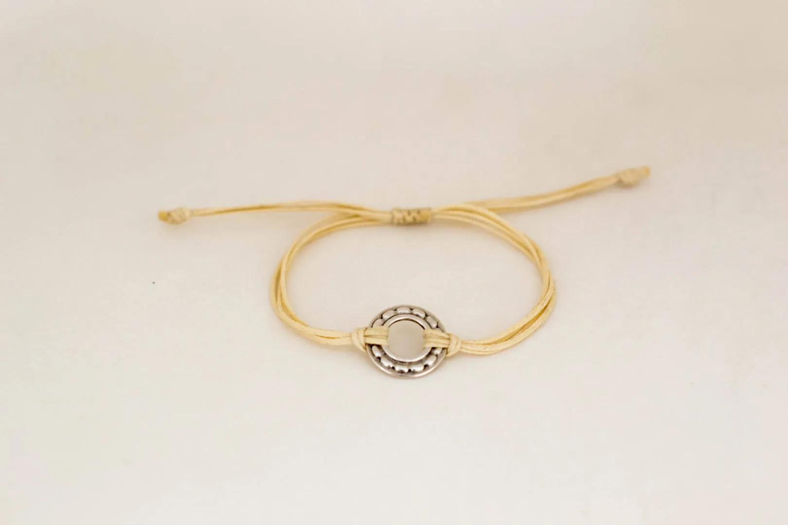 Silver Karma bracelet, beige cord, adjustable sliding knot