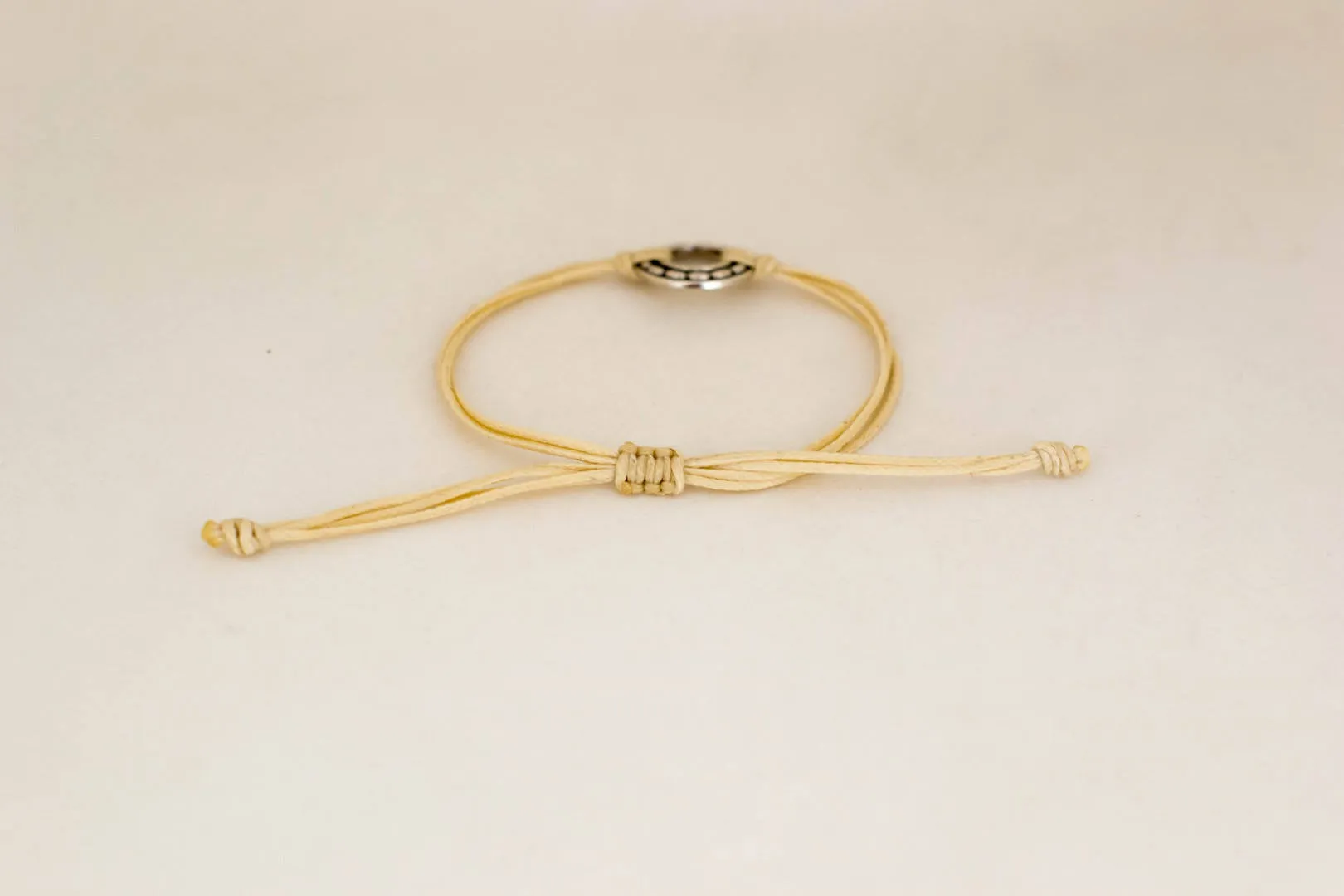 Silver Karma bracelet, beige cord, adjustable sliding knot